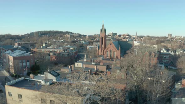 Aerial Drone Shot Ascending Past a Street and  Church Steeple in Suburban Boston