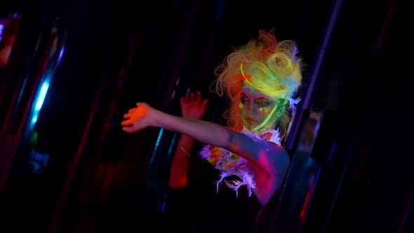 Mysterious Woman in Uv Lights in Darkness Glowing Fluorescent Makeup and Hair