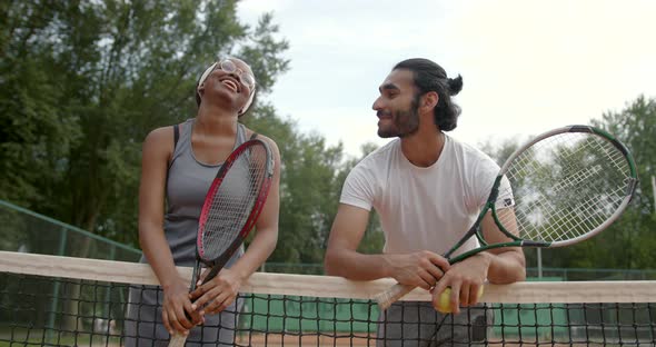 Couple of Tennis Players Talking at the Court After a Match