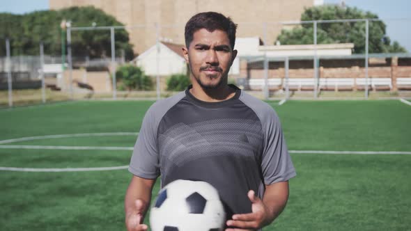 Soccer player looking at camera on the field