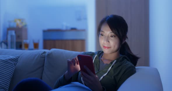 Woman use of smart phone for online shopping at night