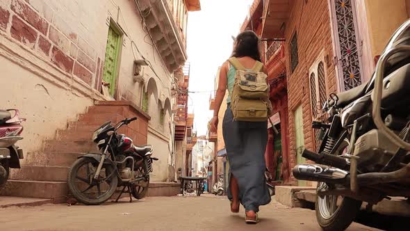 Female Tourist Walks Through the Streets of an Indian City