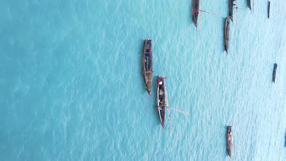 Vertical Video Boats in the Ocean Near the Coast of Zanzibar Tanzania Aerial View