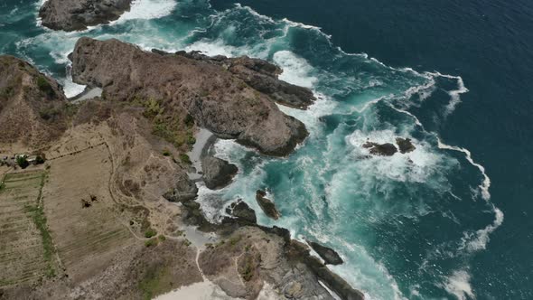 Cliff and Sparkling Ocean Waters with Waves Crashing Against Rocks