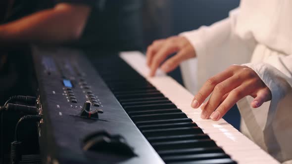 Female Hands Playing Eletric Piano on Stage