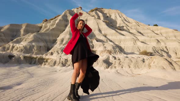 Happy Girl Dancing on the Mountains with Red Dress