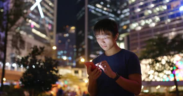 Man Use of Mobile Phone in The Street at Night