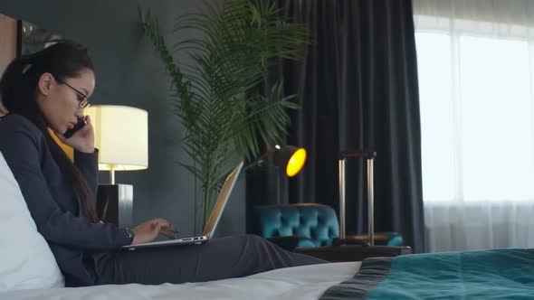 Asian Woman Working from Comfortable Hotel Room