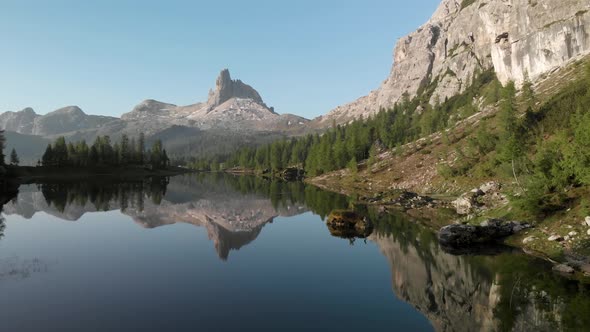 Aerial Flying over Mountain Lake Federa in Dolomites Alps Italy