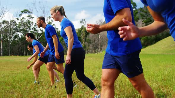 Fit people jogging in boot camp 4k