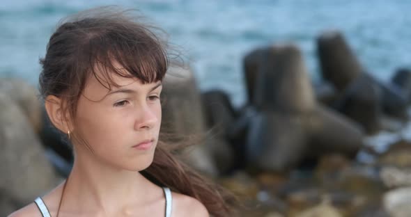 Teen By Rocks on Beach