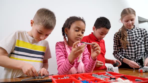 Kids Using Building Kit To Create Toys