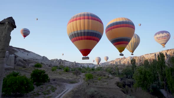 Cappadocia, Turkey: Drone shot of many hot air balloon flying over idyllic Love Valley