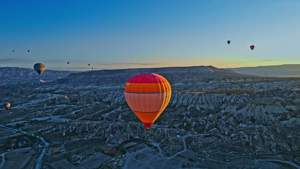 Sunrise and Hot Air Balloons Taking Off Over Valley