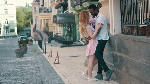 Young Couple in Love Standing and Tenderly Cuddling on Streets of European Cities