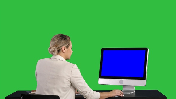 Woman Working Looking at Monitor at Office on A Green Screen