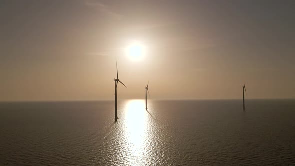 Windmill Silhouette Spinning on calm waters, scenic seascape, eolic energy Concept