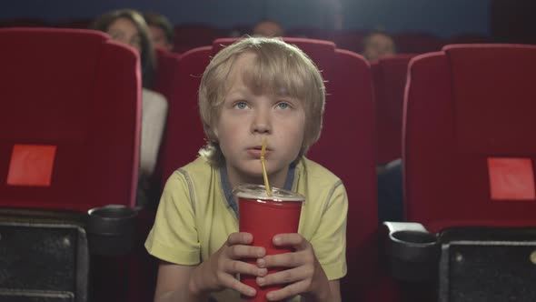 Caucasian Boy Watching Action in Cinema