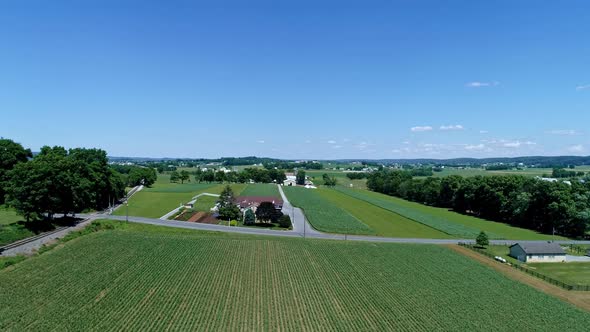 Aerial View of the Farm Countryside With Planted Fields and a Single Rail Road Track