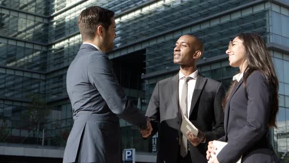 Cheerful Business Colleagues Talking on Street