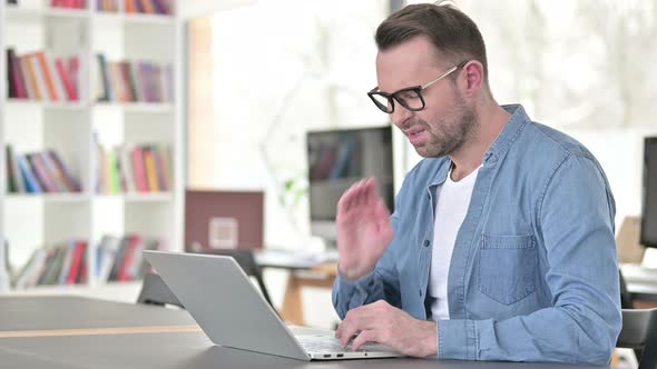 Young Man Having Neck Pain at Work