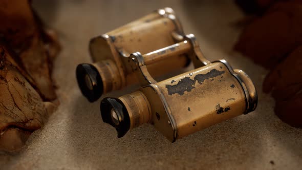 Old German Military Binoculars on the Sand Beach