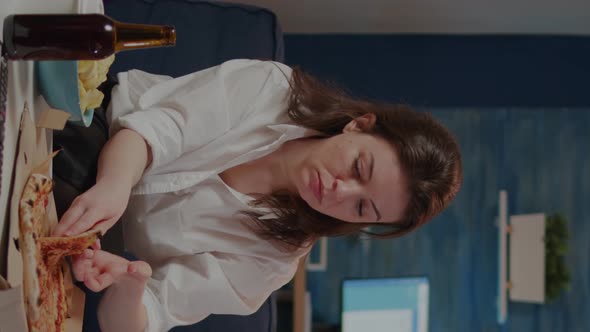 Vertical Video Young Woman Eating Slice of Pizza From Box and Drinking Beer