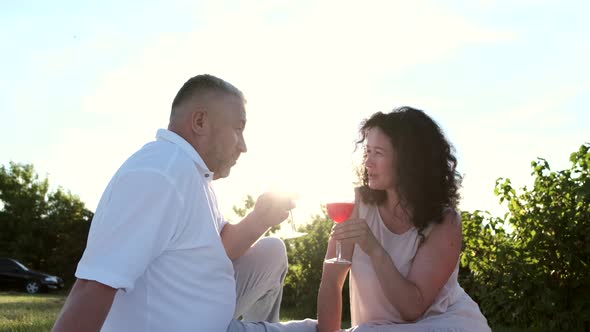 Mature Couple on a Picnic Date in the Garder