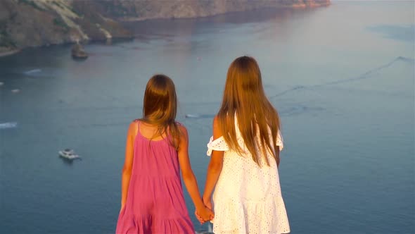 Children Outdoor on Edge of Cliff Seashore