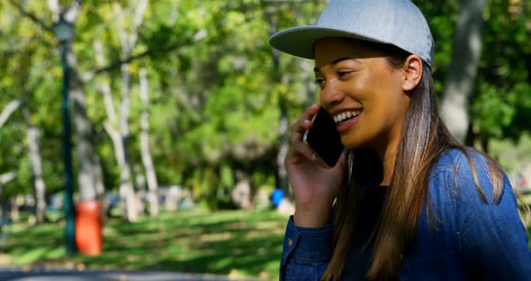 Woman Talking on Mobile Phone in The Park 4k