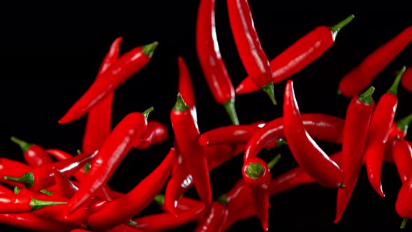 Super Slow Motion Shot of Flying Red Chilli Peppers in the Air at 1000Fps