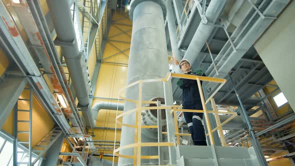 Young Engineer Wearing Protective Helmet Posing at Modern Factory