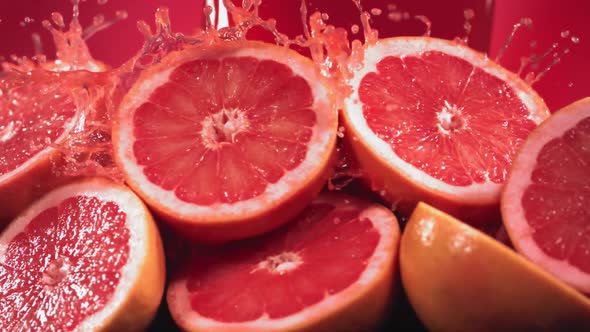 Slow Motion Shot of Grapefruit Juice Splashing Through Grapefruit Slices