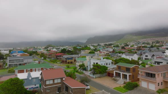 Backwards Fly Above Streets and Bouses in Residential Borough of Kleinmond