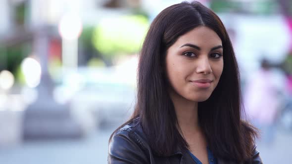 Pretty young asian woman turning his head and smiles at camera- outdoor