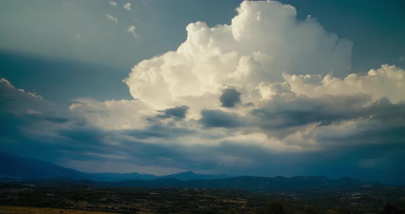 Clouds on Sky Growing in Timelapse on Mountain and Rural Fields at Horizon