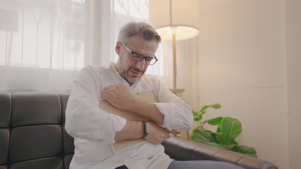 Old man elderly looking at frame of photograph then hug with sadness