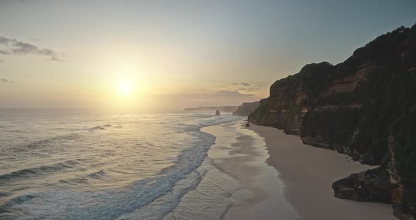 Slow Motion Sun Sunrise at Ocean Wave with Cliff Sand Beach of Bawana Aerial View