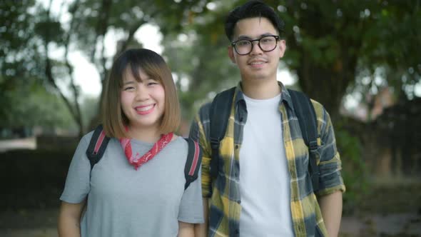 Traveler Asian couple feeling happy smiling to camera holiday trip at Thailand, backpacker sweet