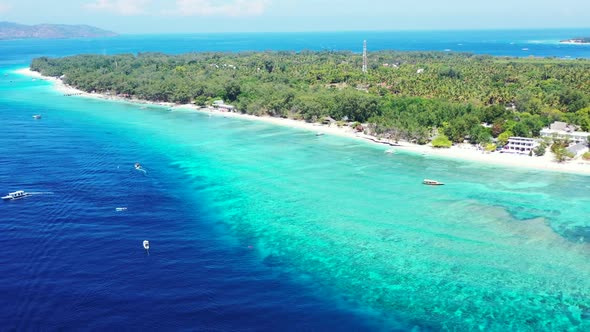 Aerial top view scenery of idyllic lagoon beach trip by blue water and white sandy background of jou