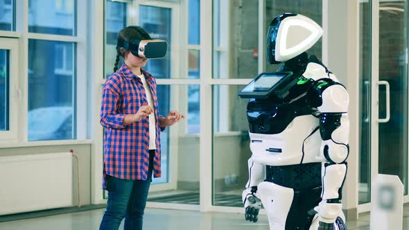 Teenage Girl in VRglasses and a Cyborg Chatting with Her