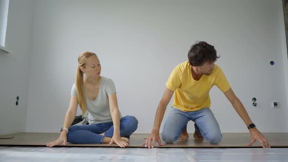 A Family of Woman and Man Install Laminate on the Floor in Their Apartment