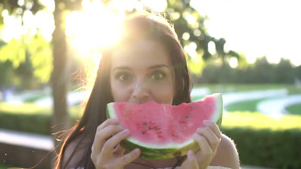 Happy Beautiful Woman Eating Red Watermelon in Nature Outdoors Slow Motion