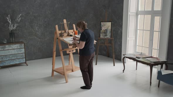 Elderly Female Artist Painting in the Art Studio