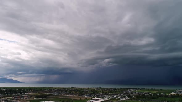 Hyperlapse of dramatic storm moving over the landscape from aerial view