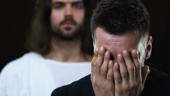 Jesus Christ Healing Sick Crying Man, Closing Face With Hands, Dark Background