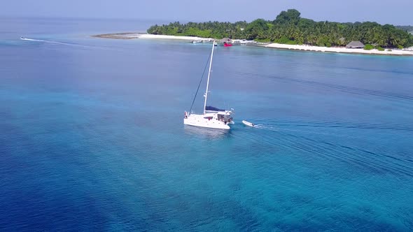 Sunny panorama of resort beach time by blue water with sand background near sandbank