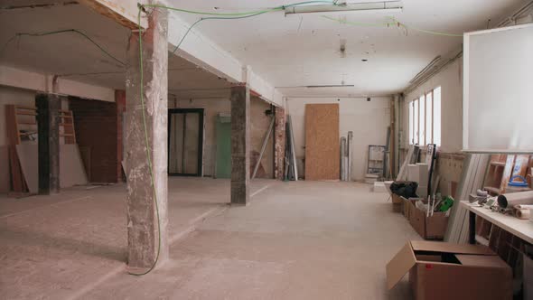 Camera Pans Around a Room that is a building site with exposed walls and cables daytime interior