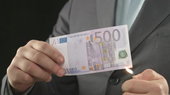 Male in Suit Burning Euro Bill, Money Devaluation, Inflation and Crisis, Closeup