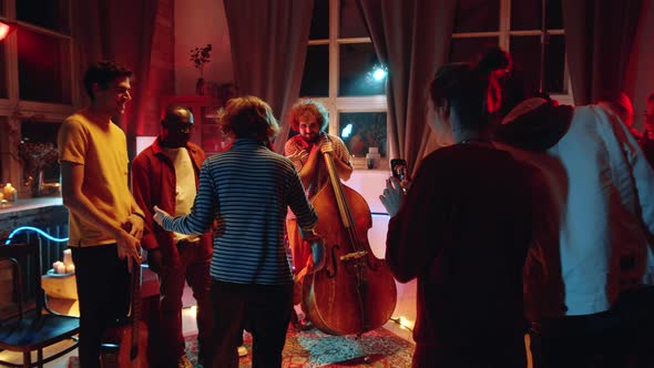 Woman Taking Picture with Music Band after Concert